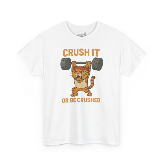 White t-shirt with a cartoon cat lifting weights and text 'CRUSH IT OR BE CRUSHED' on a white background